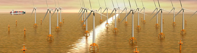 A heavy-lift vessel installing large foundations for an offshore wind farm in the open sea
