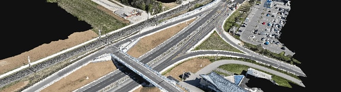 3D rendered aerial view of a highway interchange with multiple roads, parking lots, cars, and a building; menu overlay present in the upper left corner.