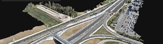 3D rendered aerial view of a highway interchange with multiple roads, parking lots, cars, and a building; menu overlay present in the upper left corner.