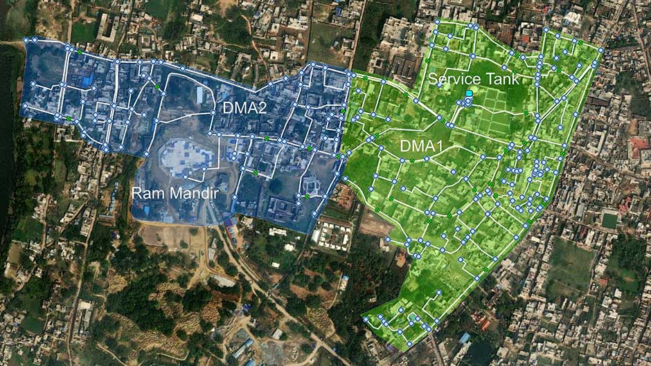 Aerial map shows two zones labeled DMA2 (blue, includes Ram Mandir) and DMA1 (green, includes Service Tank), overlaid on an urban area with roads and buildings.