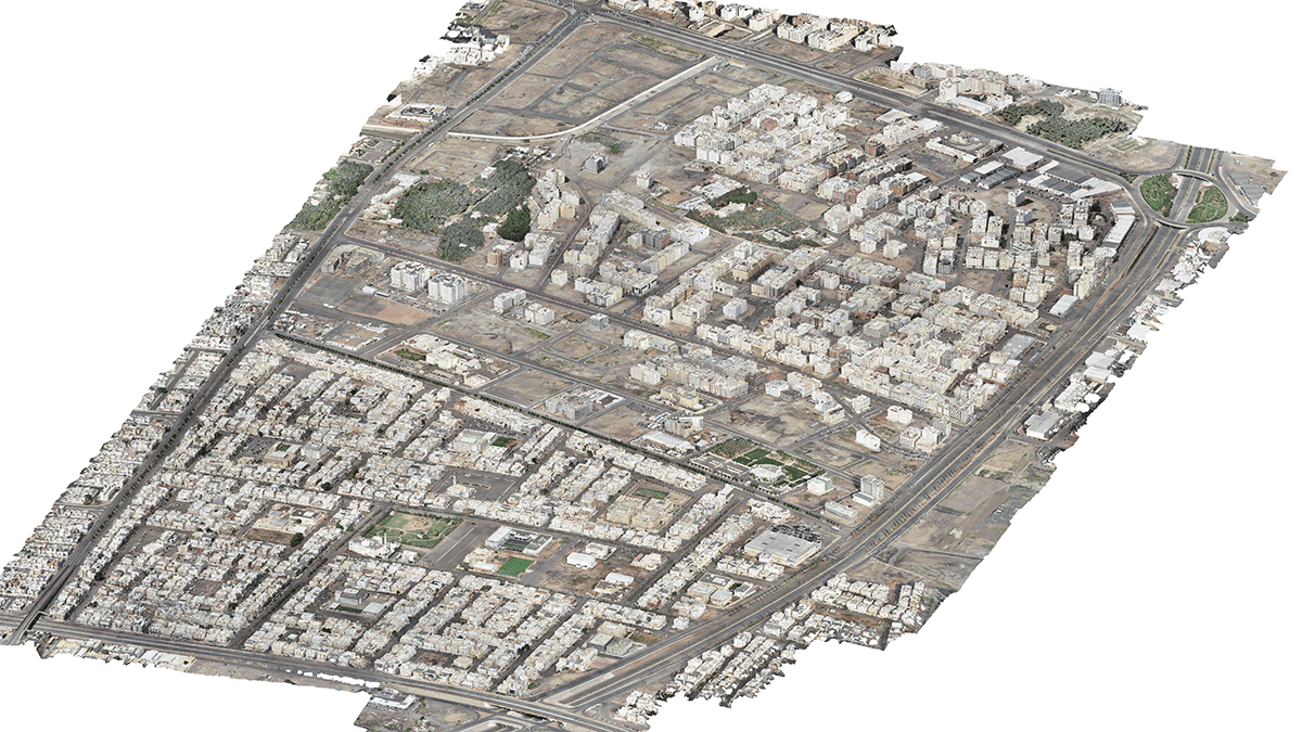 Aerial view of Madinah smart city with dense buildings, roads, and sparse green spaces, highlighting a mix of residential and commercial structures as part of the MDA YII Project.