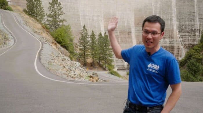 Man in front of dam