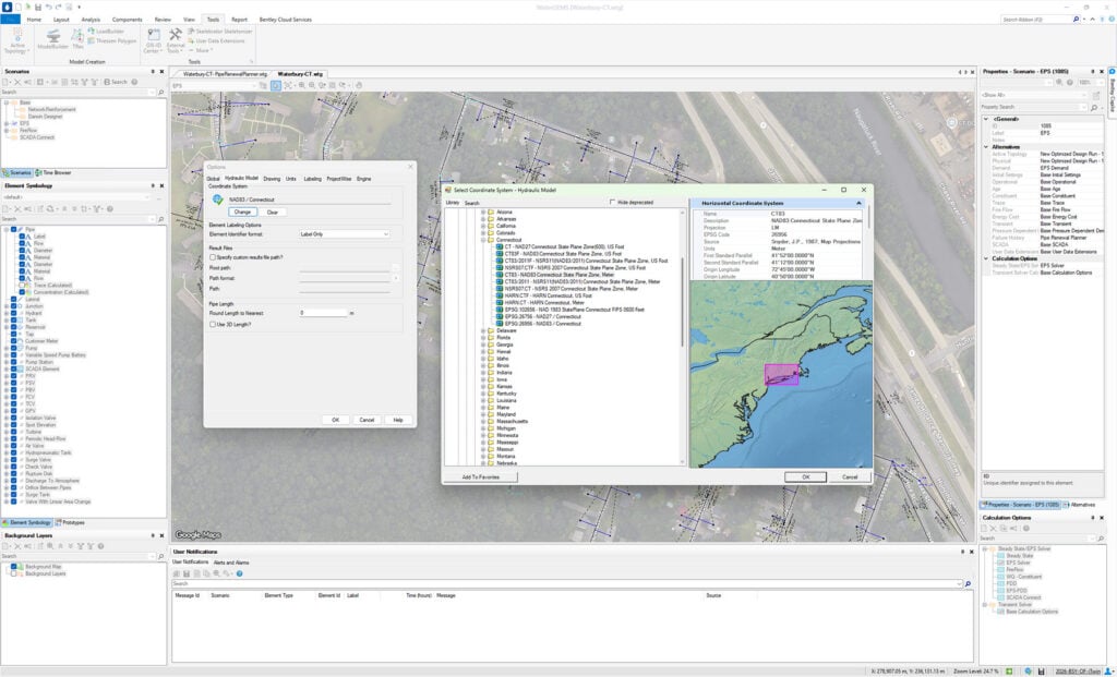 A computer screen displays the OpenFlows 2026 GIS software interface with map layers, a tool window, and a dialog box for selecting a coordinate system and adjustment parameters.