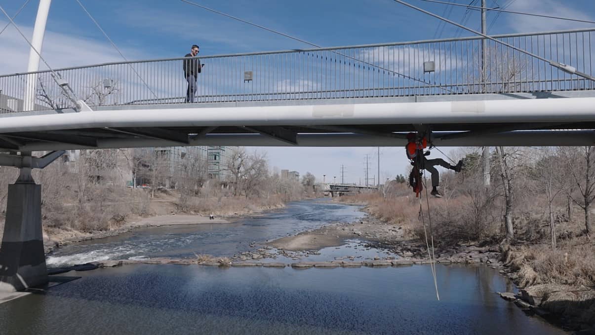 construction worker under pedestrian bridge