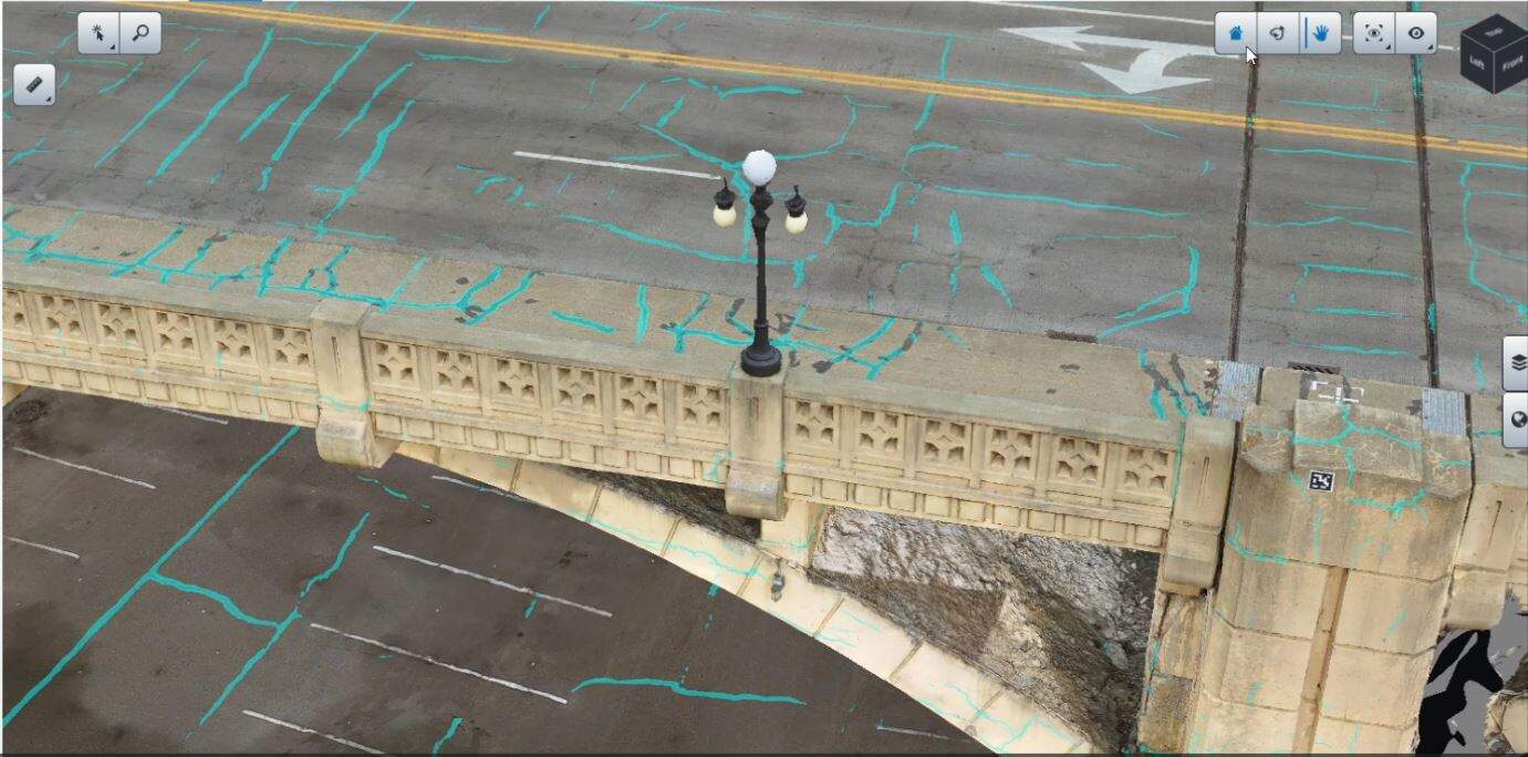 A bridge with detailed road markings viewed from above, showing a lamppost and multiple lanes.