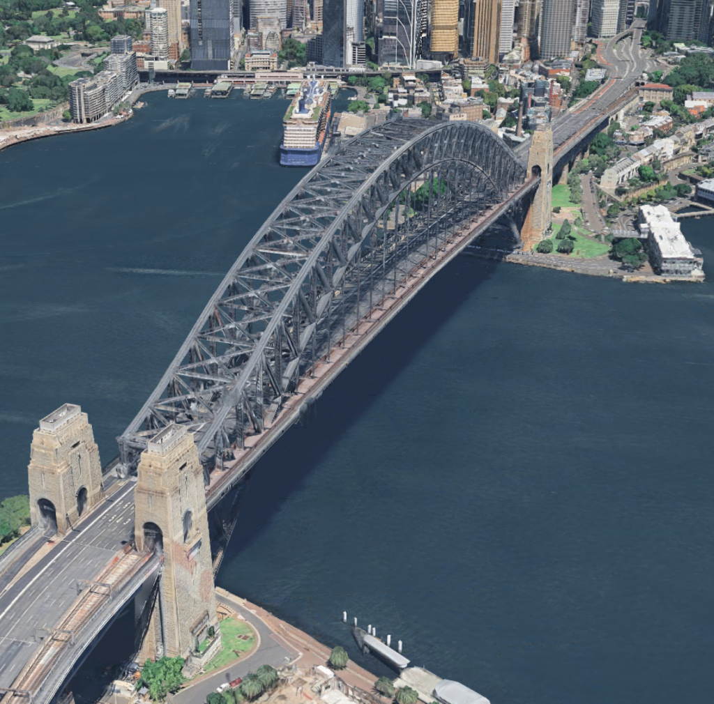 Aerial view of the Sydney Harbour Bridge spanning across Sydney Harbour, capturing the vibrant harbor city landscape and iconic skyline.