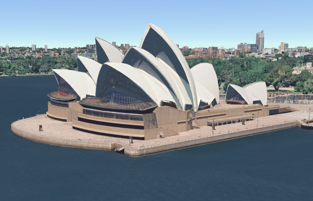 Aerial view of Sydney's iconic Opera House, with its distinctive white sail-shaped roofs, situated on the harbour.