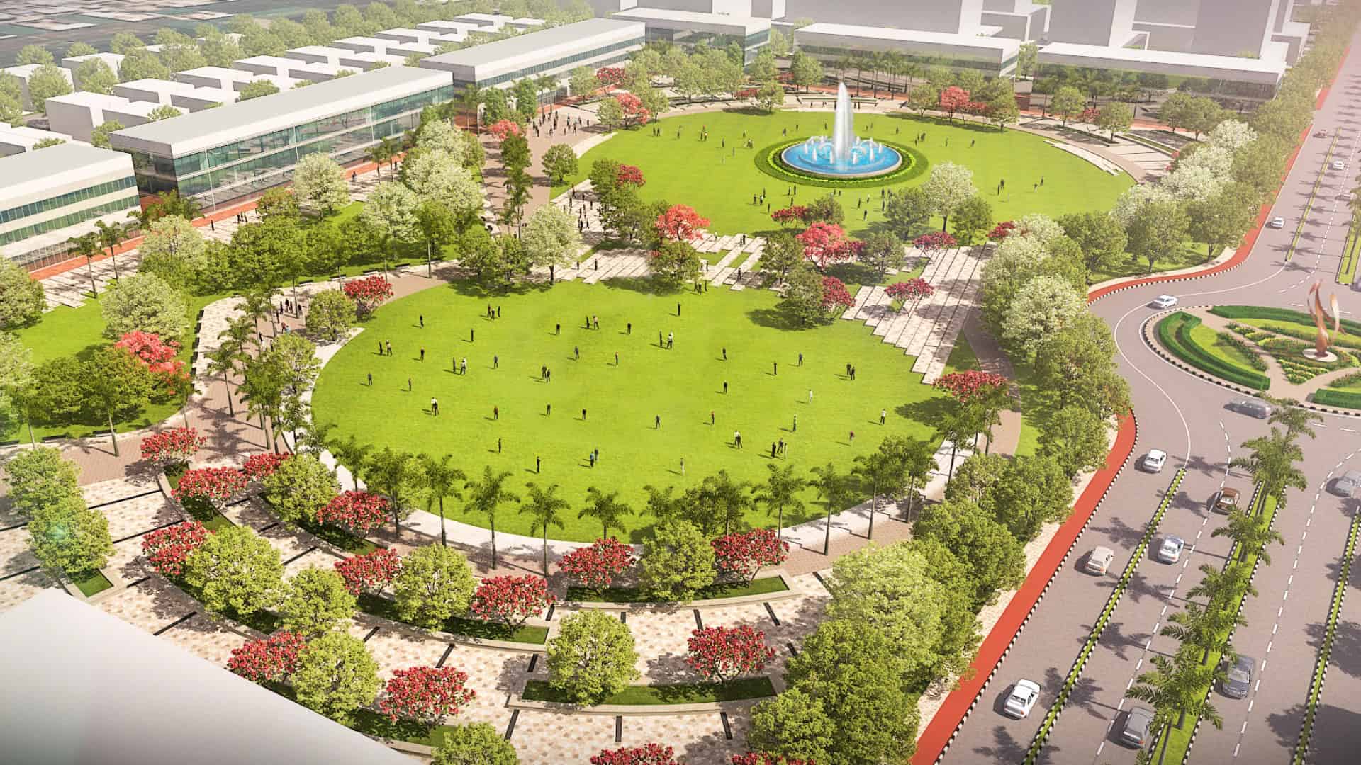 Aerial view of a large urban park at Atal Puram Township, featuring a central green lawn, fountain, walking paths, lush trees, and surrounding roads with traffic—crafted using advanced design tools by Voyants Solutions.