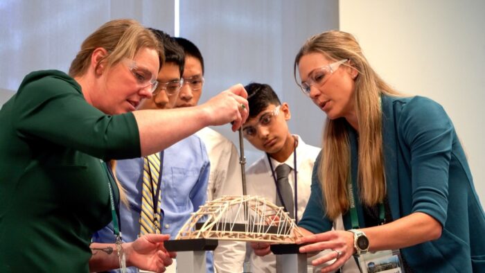 Tied Arch Titans, the 9th and 10th grade winners, are shown here testing the bridge strength to weight ratio. Image courtesy of Bentley Systems. 