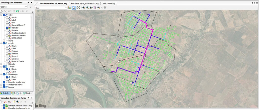 Map view showing a network layout with blue and pink lines overlaid on a satellite image, indicating water distribution systems infrastructure routes within a defined area. Various map toolbars and controls are visible.