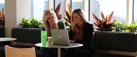 Two women working on laptop