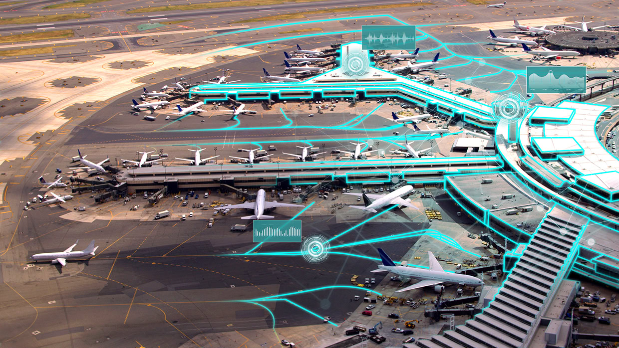Aerial view of a busy airport terminal with multiple airplanes and graphical digital data overlays representing connectivity, data analysis, and seamless airport operations.