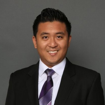 A professional headshot of a smiling man wearing a black suit, white shirt, and purple tie during a webinar series.
