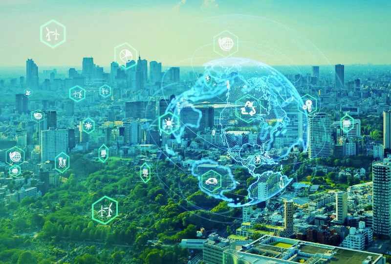 A cityscape with digital icons overlay depicting technology and sustainability, including wind turbines, water, and energy symbols, showcases Bentley Systems' Infrastructure Intelligence against a backdrop of skyscrapers and greenery.