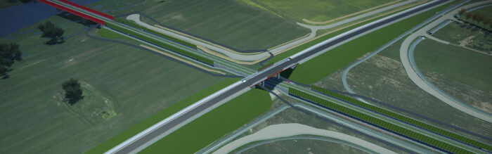 Aerial view of a modern highway and railway interchange featuring bridges, green fields, and connecting roads.