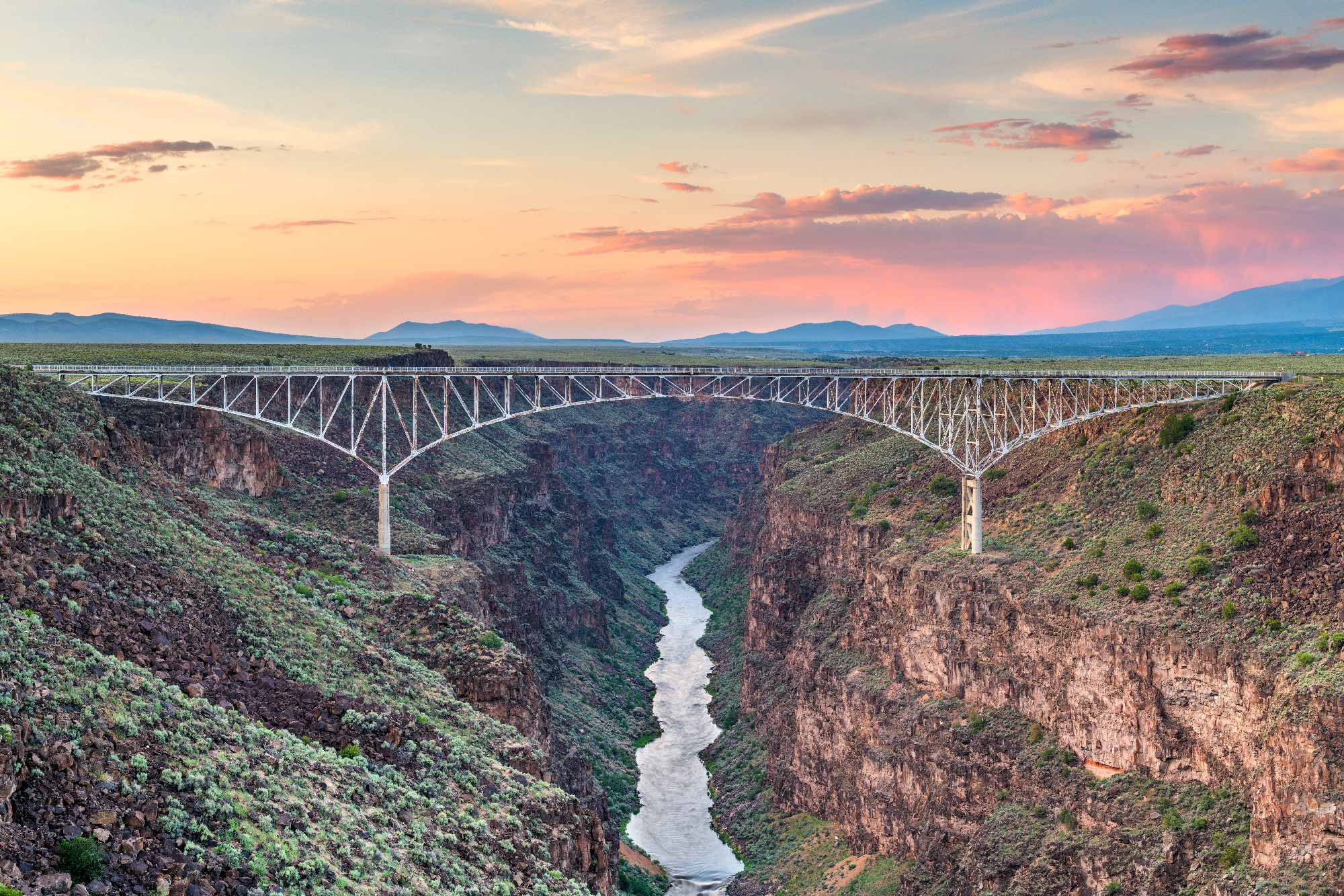 bridge across gorge and river at sunset
