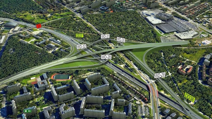 Aerial view of a transportation network featuring a complex highway interchange with multiple overpasses, surrounded by residential and commercial buildings, expertly designed using MicroStation CAD software.