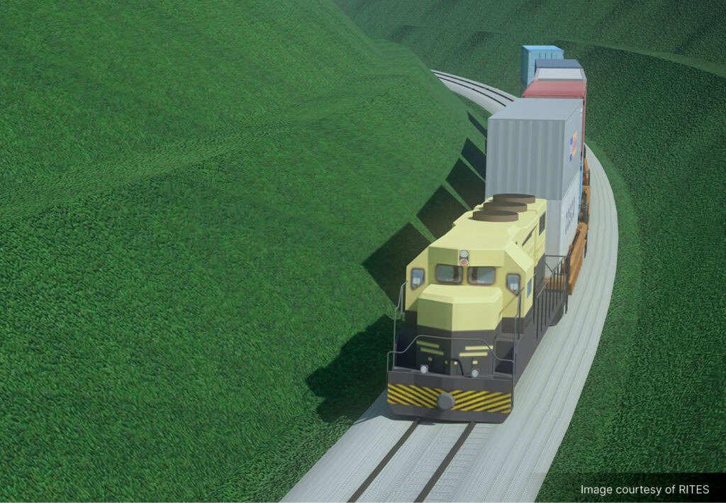A freight train carrying stacked shipping containers travels along curved tracks through green hills, highlighting the importance of rail awareness in safe and efficient transportation.