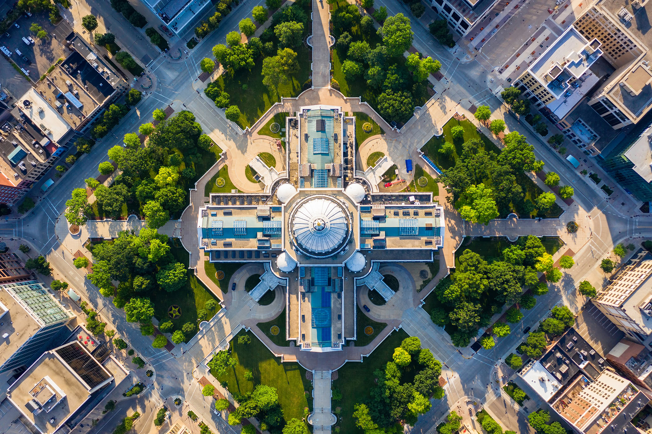 Aerial view of a large, domed building with surrounding symmetrical pathways and green spaces in an urban area, serving as a hub for Bentley participants within the Ecosystem Catalog.