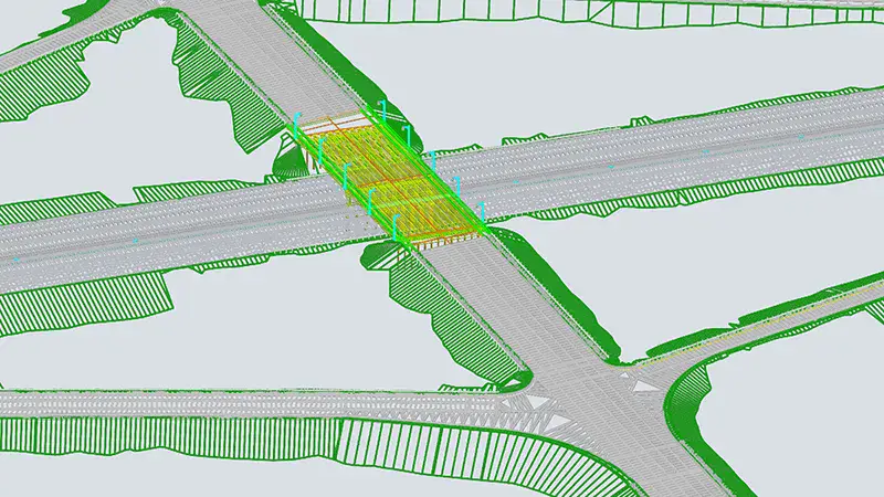 Digital rendering of a highway intersection with overpass, lanes, road markings, and green highlighted areas indicating construction or design features.
