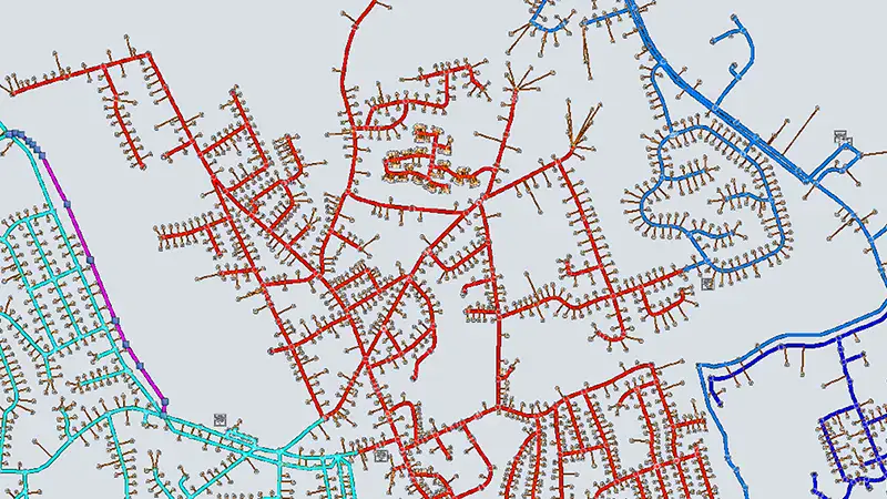 A color-coded map displays a network of interconnected streets or routes, with lines in red, blue, green, and purple on a light gray background.
