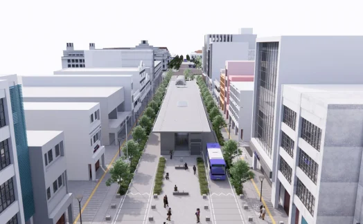 An aerial view of a city street reveals a SYNCHRO-designed modern bus stop at the center, nestled among tall buildings. Trees line the sidewalks as people walk by, illustrating urban vibrancy in this living case study of efficient public space integration.