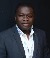 A man in a dark suit jacket and white shirt 