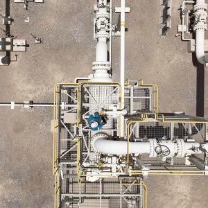 Areal view of pipe network with worker evaluating things