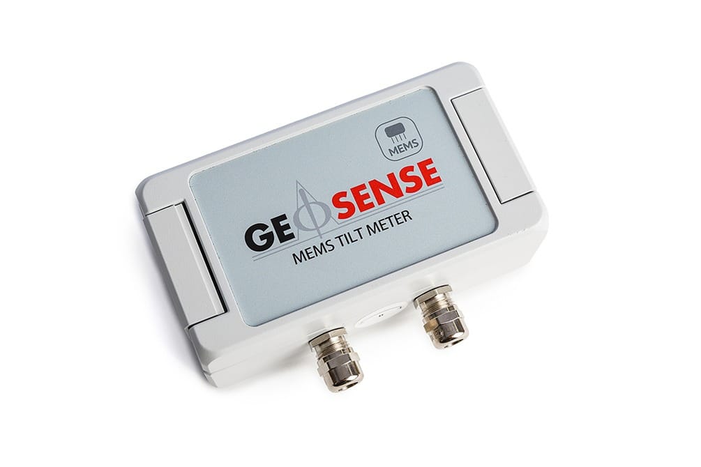 A rectangular GEOSENSE MEMS tilt meter with two metal connectors and a label on the top, photographed against a white background.