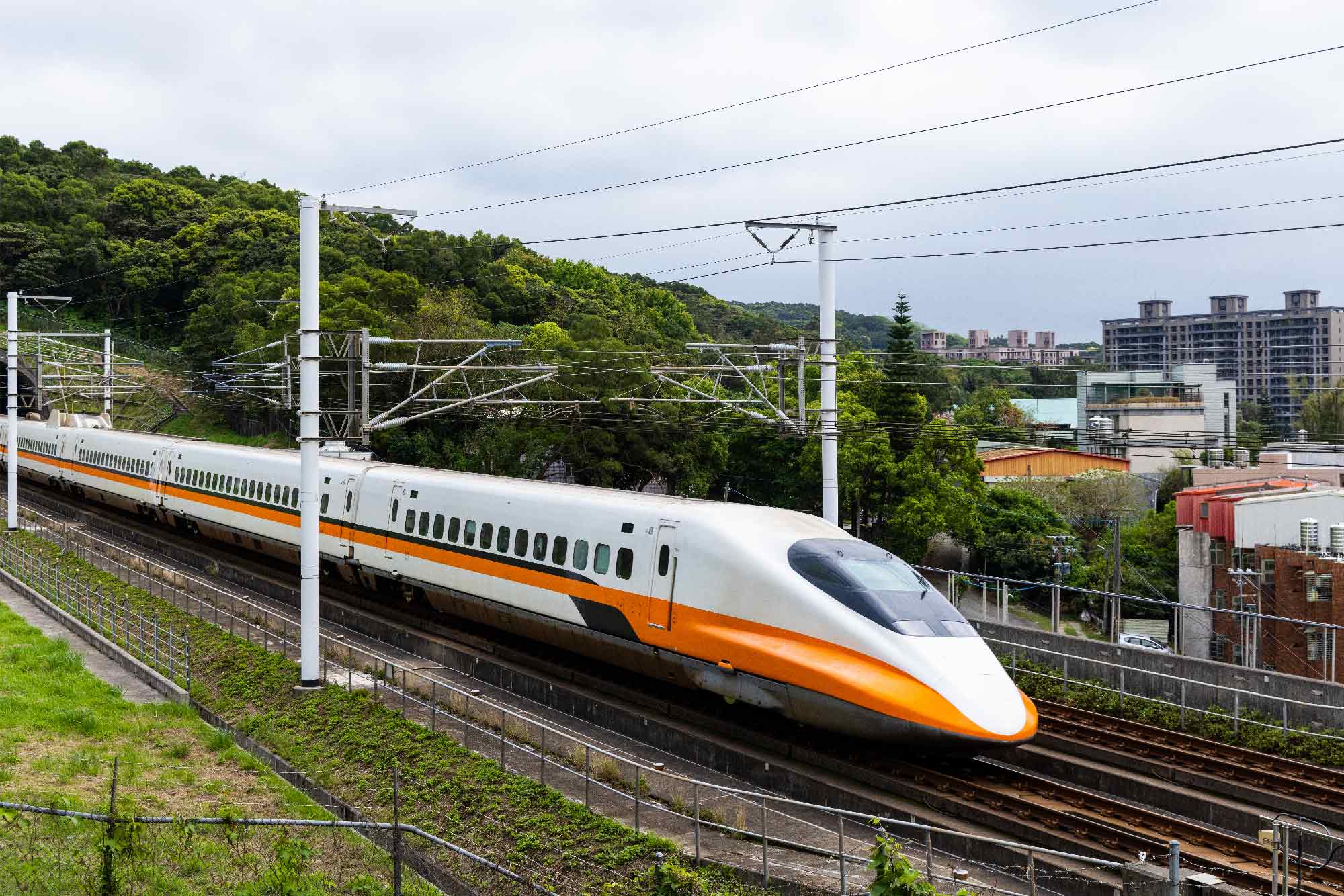 highspeed train running along tracks around a city