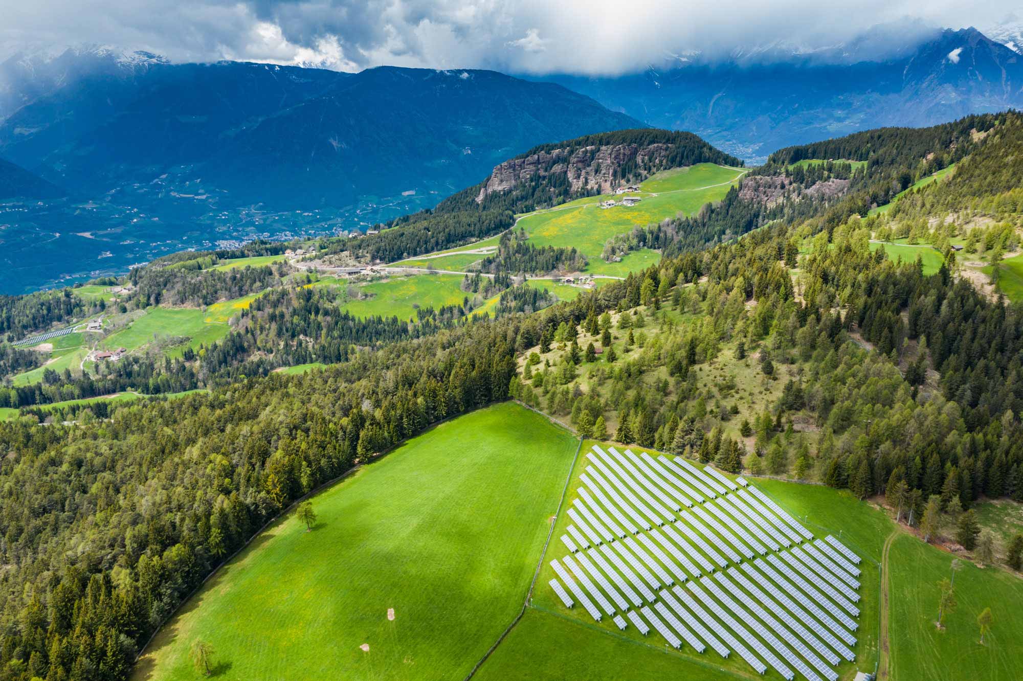 mountain and fields along with sustainability infrastructure solar panels