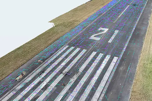 Aerial view of an airport runway with the number 2, where Infrastructure AI assists in detecting inspection markings and scattered debris on the surface.