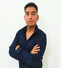 A person with short dark hair is standing against a plain white background, wearing a dark blue long-sleeve shirt. With their arms crossed, they project confidence, much like professionals in local governments managing Water and Sewer projects with OpenFlows.