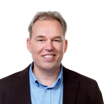 A man with light hair, wearing a blue shirt and dark jacket, smiles at the camera against a white background, as if to say "Thank You" for downloading.
