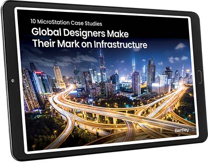 A tablet displaying the cover of a publication titled "10 MicroStation Case Studies: Global Designers Make Their Mark on Infrastructure" with an image of a cityscape featuring highways and skyscrapers.