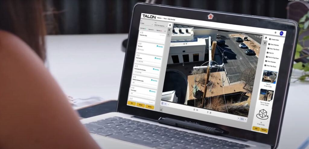 A person views an aerial image of a building and parking lot on a laptop screen using TALON