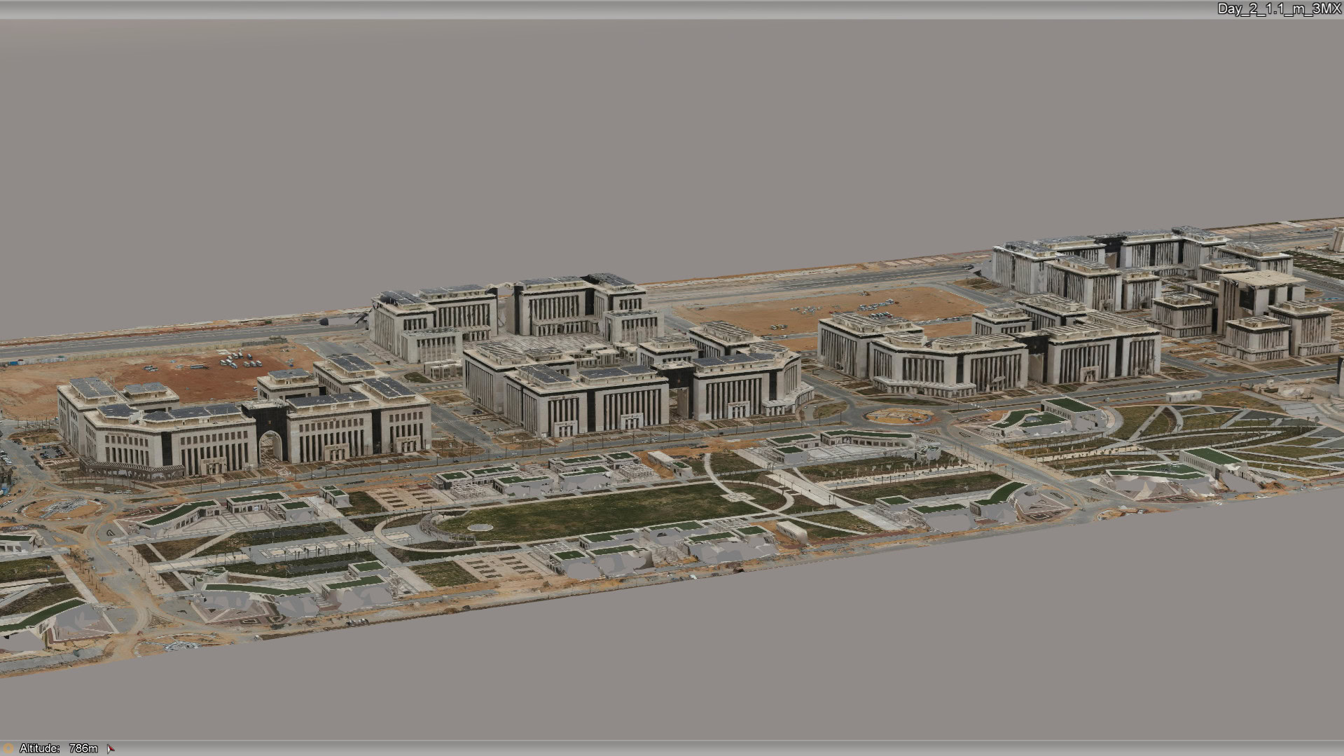 Aerial view of a large government or institutional complex, home to award winners, with multiple modern buildings and landscaped grounds in a developing area.