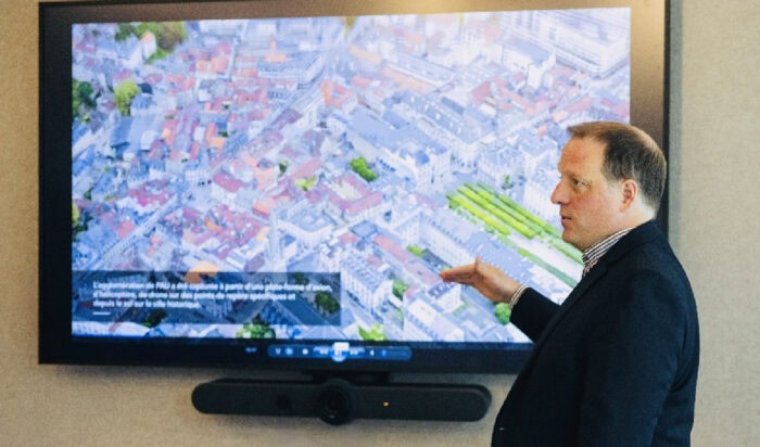 Bentley Systems’ Francois Valois, senior vice president, Bentley Open Applications, demonstrates an AI-powered city digital twin at the launch of the company’s new Québec City technology hub. Image courtesy of Bentley Systems.