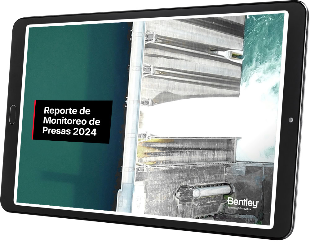 The tablet displays "Reporte de Monitoreo de Presas 2024," providing an aerial view of a dam, crucial for condition monitoring in LATAM.