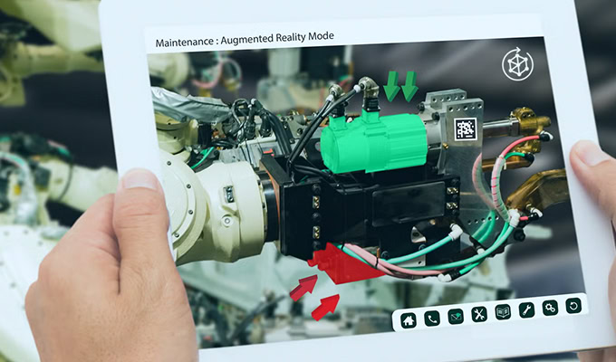 Hands holding a tablet displaying augmented reality maintenance instructions for machinery, including highlighted components and a QR code.