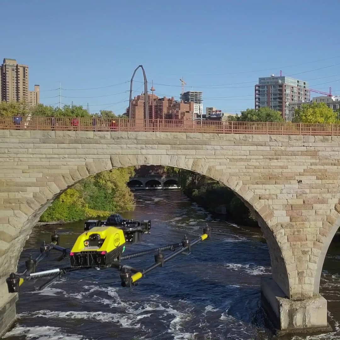 Drone flying near a stone brick bridge
