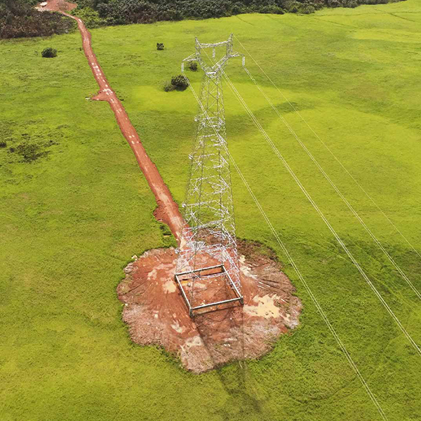 An aerial view of an electricity pylon in a field.