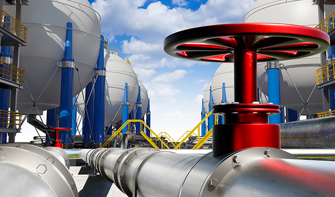 A red pipe stands alone in the field.