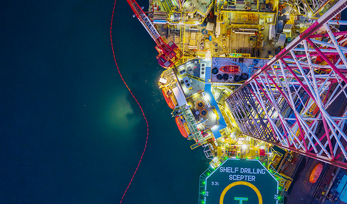 An aerial view of an oil rig at night.