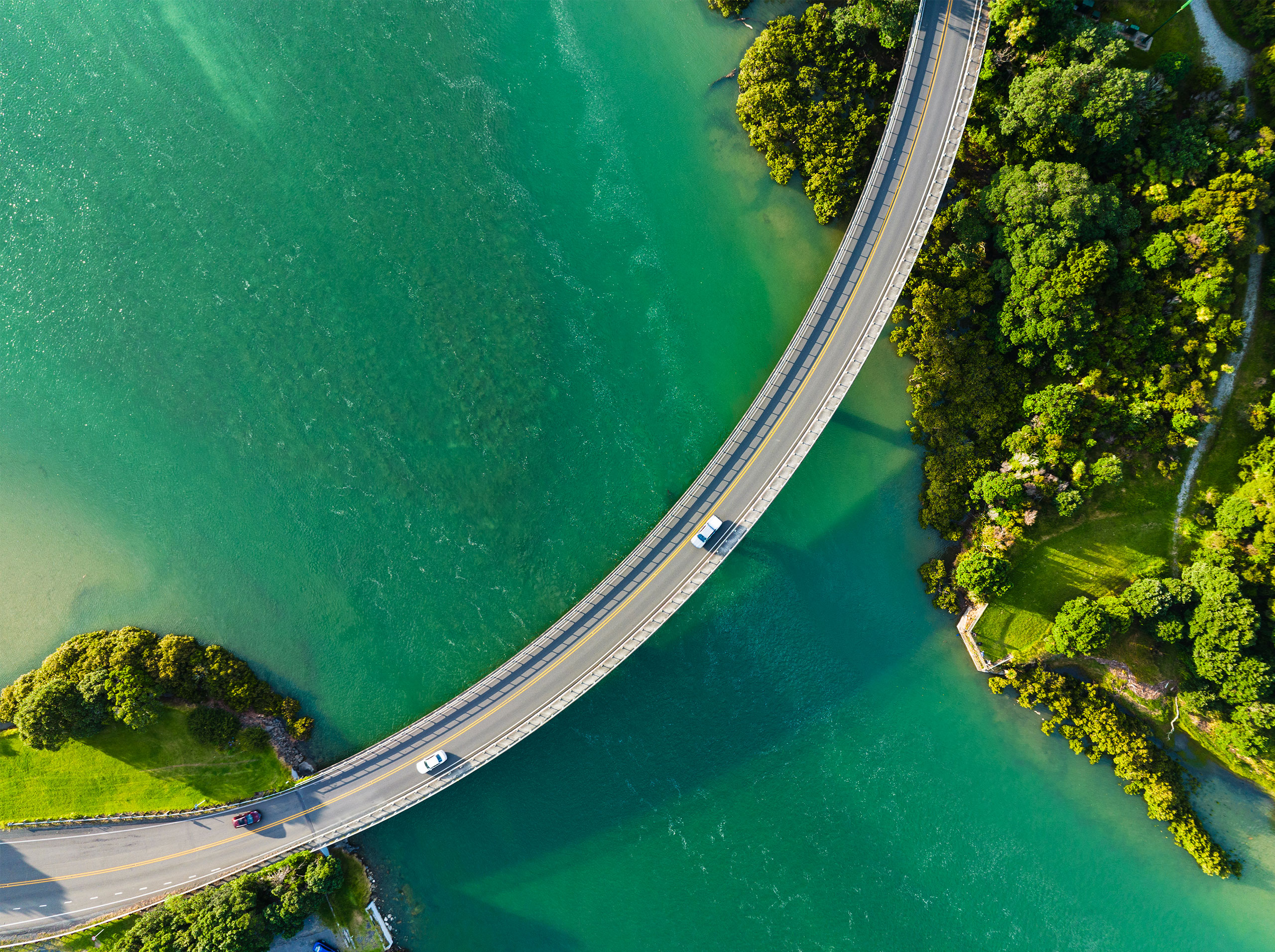 Cars passing through bridge that connecting two sides.