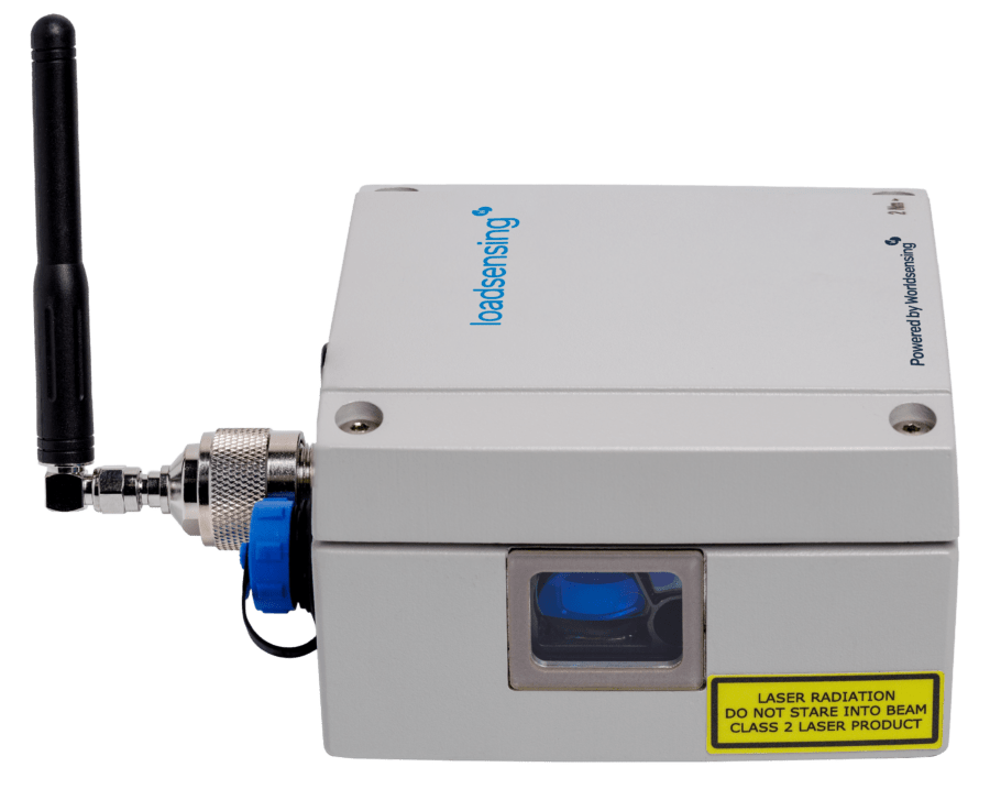 A gray Loadsensing device with an antenna, blue port, and a visible laser window, labeled with a yellow laser radiation warning sticker.