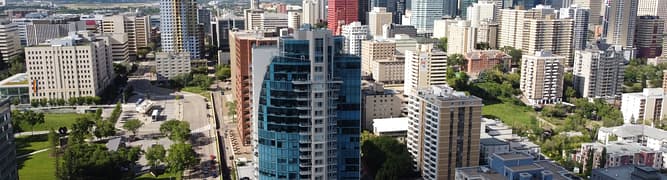 An aerial photograph of the downtown Edmonton skyline, the subject of a comprehensive, survey-grade 3D digital twin created by the City of Edmonton for urban planning and management.