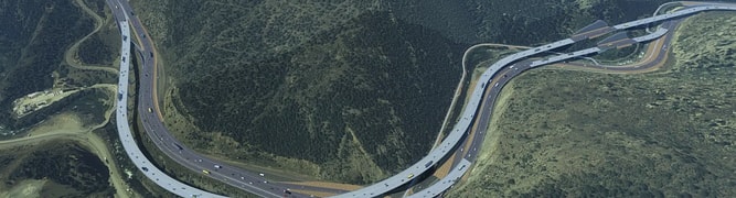 An aerial rendering of the Floyd Hill highway interchange, showing its complex network of roads and bridges winding through a green, mountainous region.